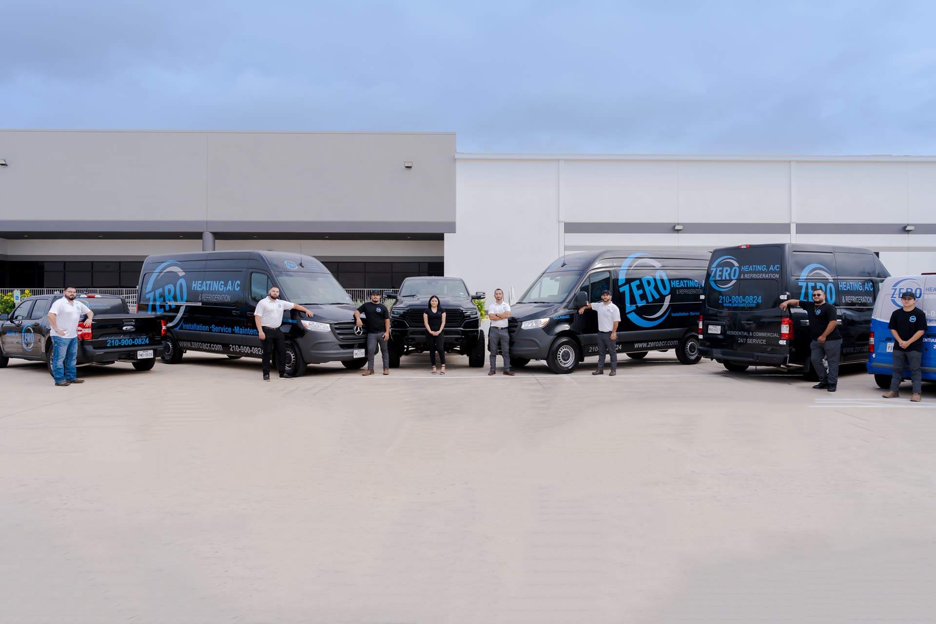 The Zero Heating AC & Refrigeration crew with their wrapped service vans and trucks in San Antonio